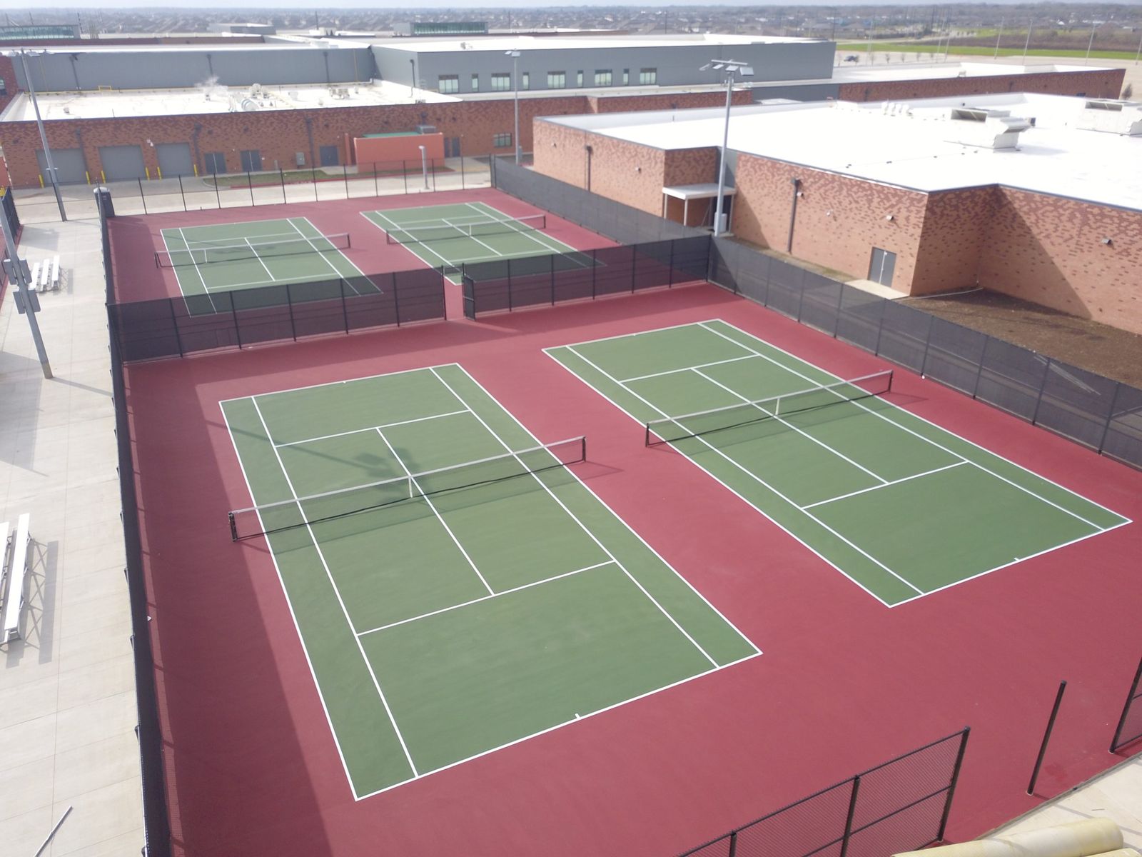 Aerial view of a newly constructed high school athletic field and running track by Fielder’s Choice