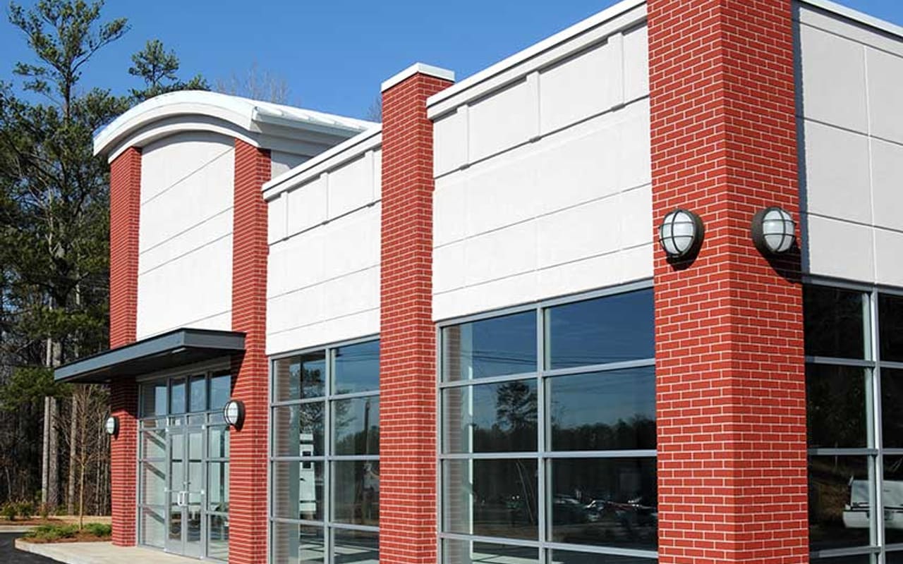New ground-up commercial building with brick and glass storefront