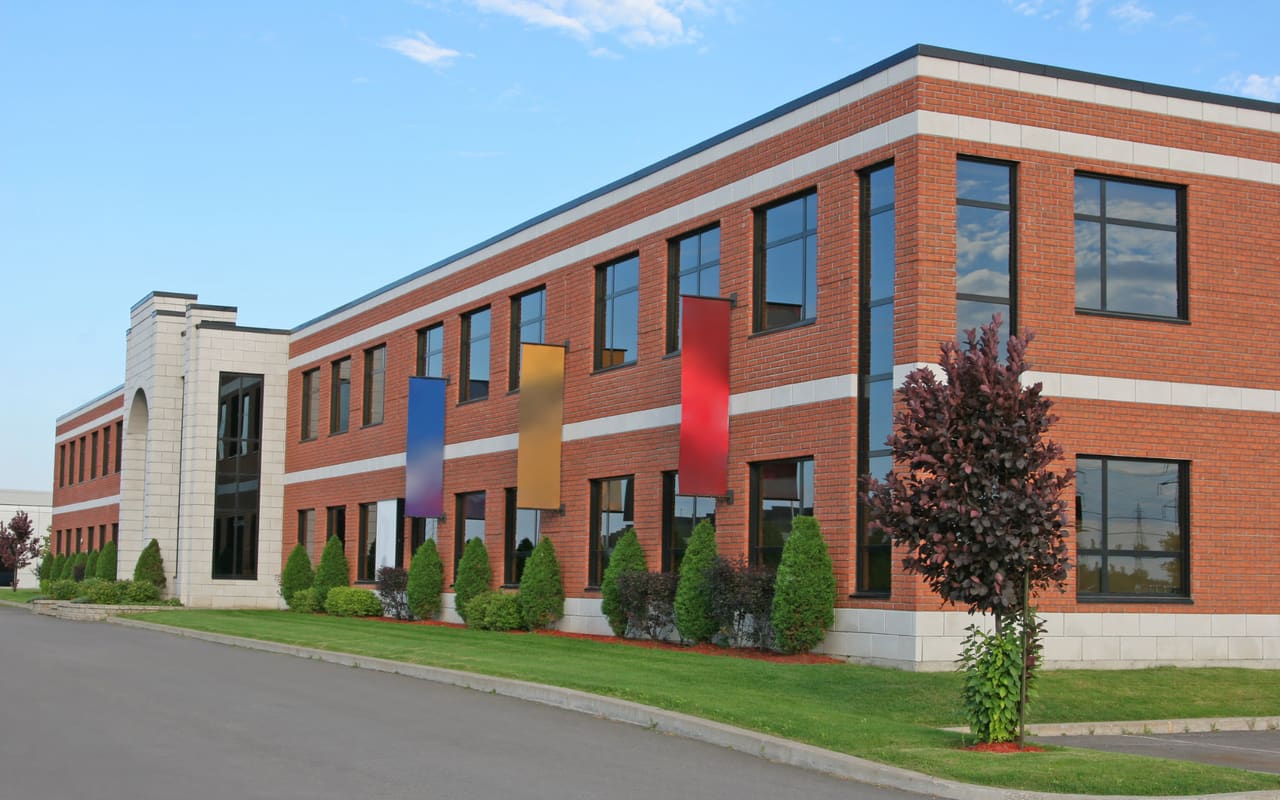 Two-story brick K-12 school building with banners at the entrance