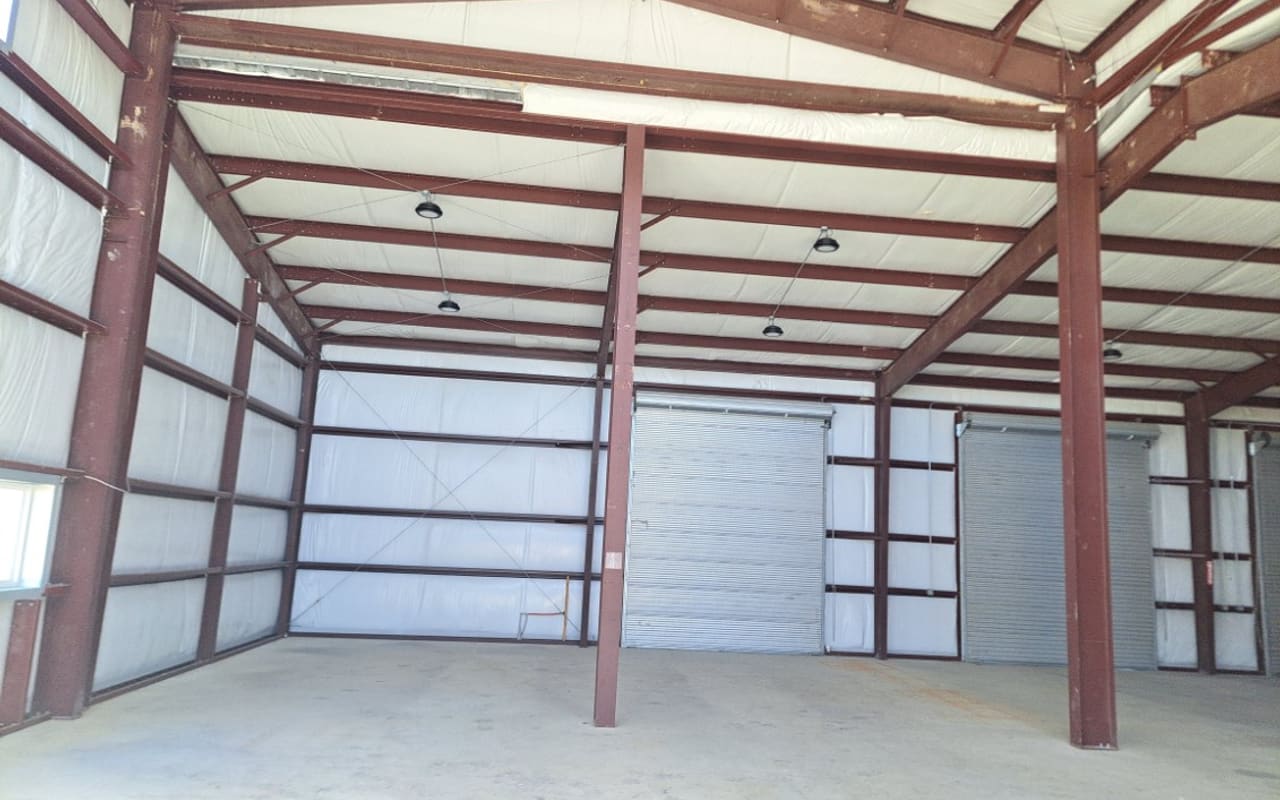 Pre-engineered metal building interior with clear-span steel framing
